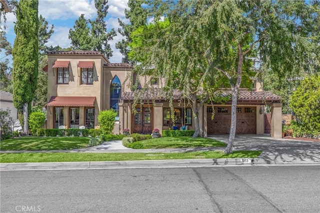 mediterranean / spanish house with a front yard