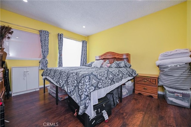 bedroom with dark wood-type flooring and a textured ceiling