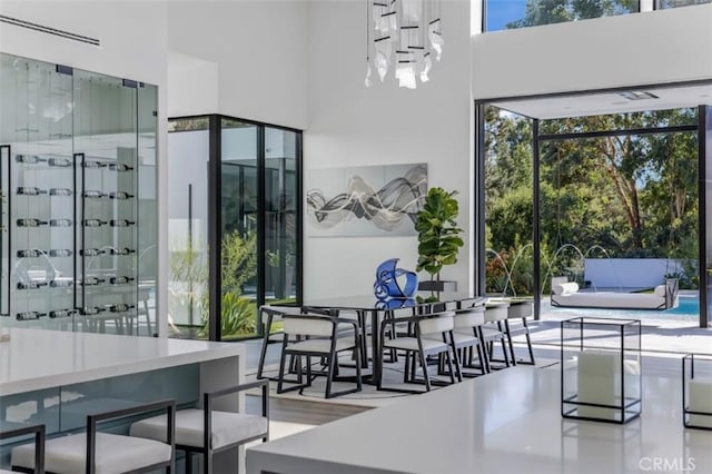 dining area with a towering ceiling