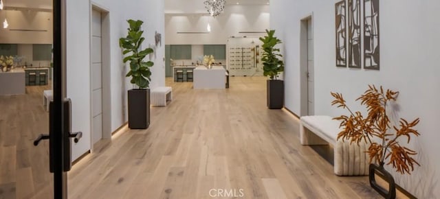 hallway with light hardwood / wood-style flooring