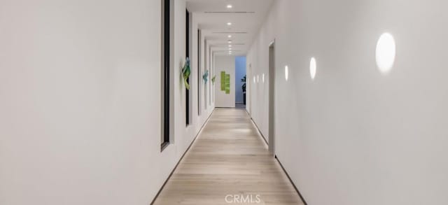 hall with light hardwood / wood-style flooring