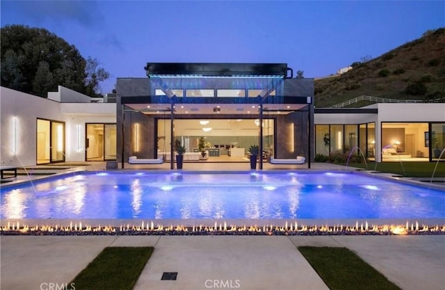 view of swimming pool featuring a patio and pool water feature