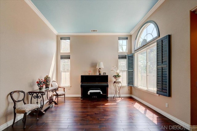 living area with ornamental molding and dark hardwood / wood-style floors