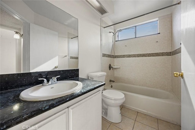 full bathroom with tiled shower / bath combo, vanity, tile patterned flooring, and toilet