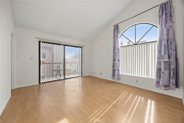 empty room with lofted ceiling and light wood-type flooring