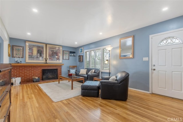 living room with light hardwood / wood-style flooring and a fireplace