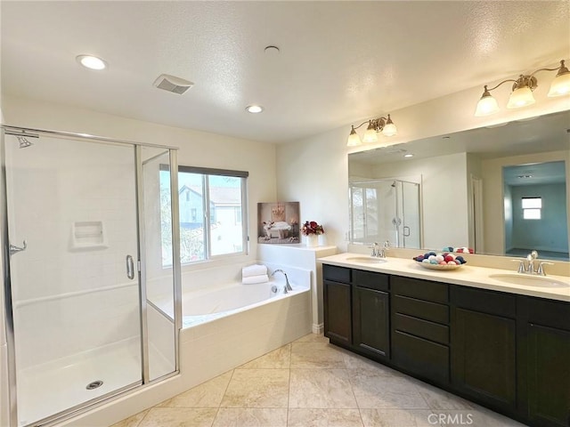 bathroom featuring vanity, tile patterned flooring, and separate shower and tub