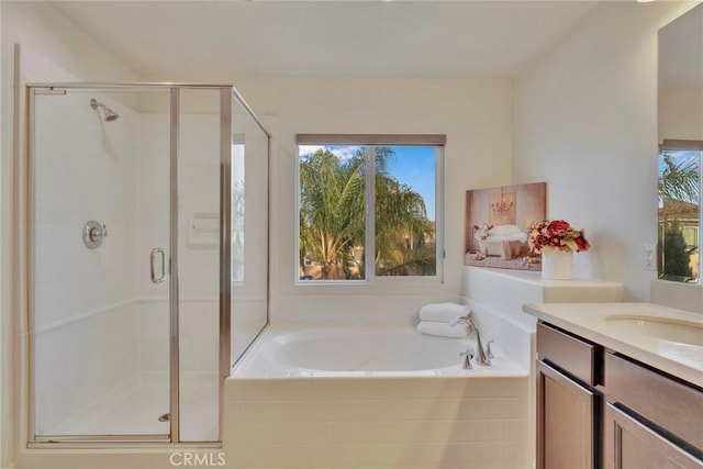 bathroom with vanity and shower with separate bathtub