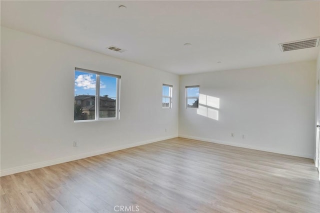 unfurnished room with light hardwood / wood-style floors