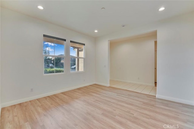 empty room with light hardwood / wood-style flooring