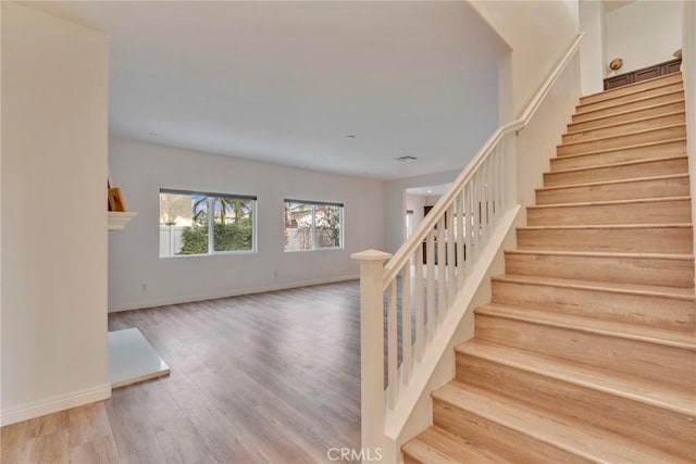 stairs with hardwood / wood-style floors