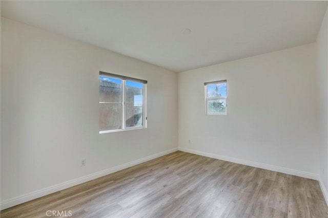 empty room with light hardwood / wood-style floors