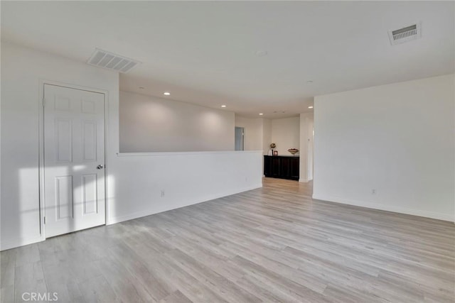 spare room with light hardwood / wood-style flooring