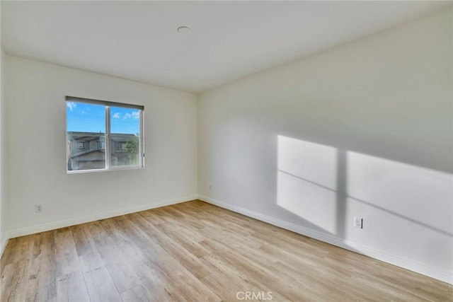 empty room with light hardwood / wood-style floors