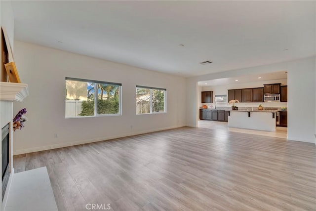 unfurnished living room featuring light hardwood / wood-style flooring