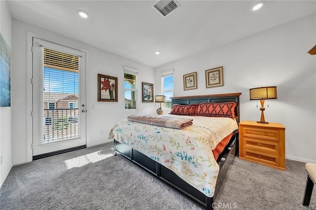 carpeted bedroom with multiple windows and access to exterior