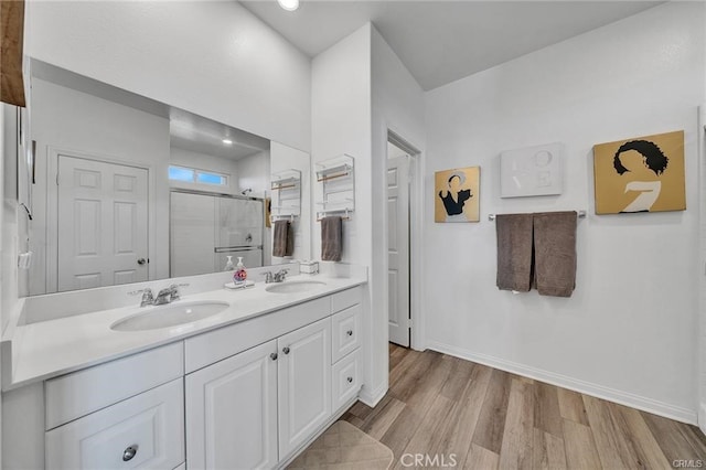 bathroom featuring vanity, hardwood / wood-style floors, and a shower with shower door