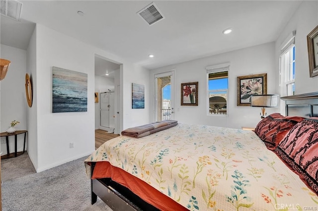 carpeted bedroom featuring multiple windows