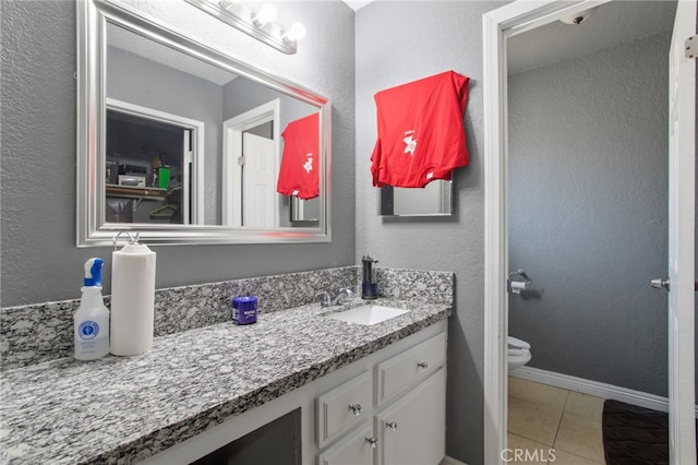 bathroom with tile patterned floors, vanity, and toilet