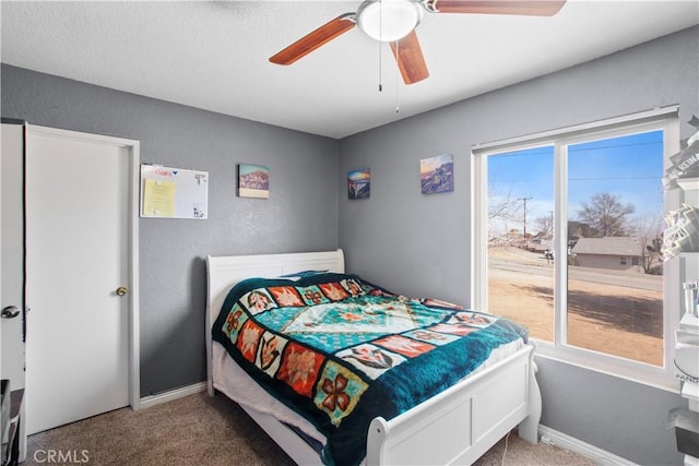 bedroom with ceiling fan and carpet flooring