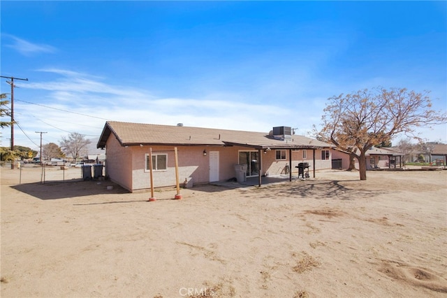 back of property featuring central AC