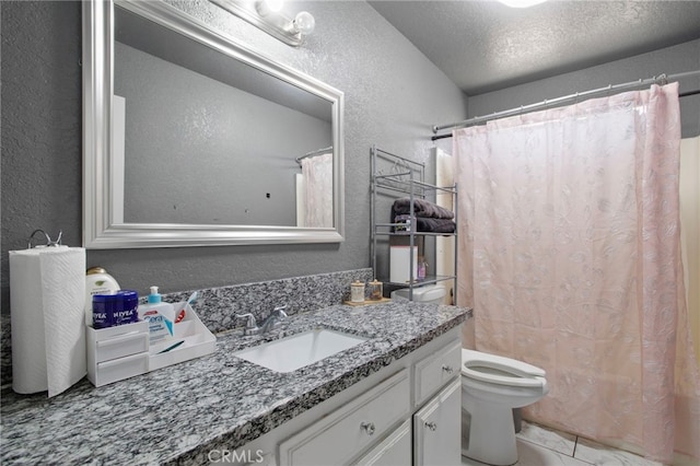 bathroom with vanity, a textured ceiling, curtained shower, and toilet