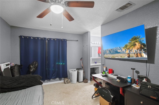 bedroom featuring ceiling fan, carpet floors, and a textured ceiling