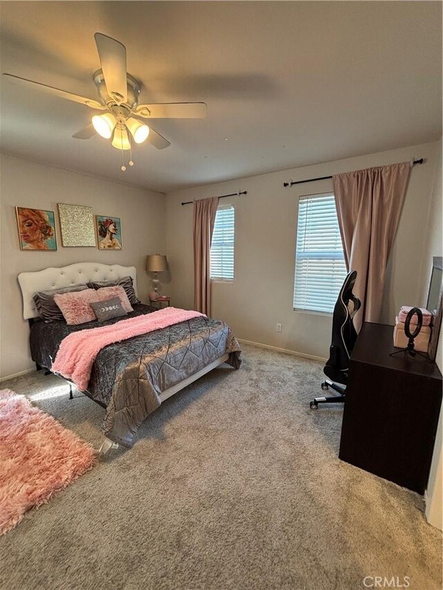 bedroom featuring ceiling fan and carpet