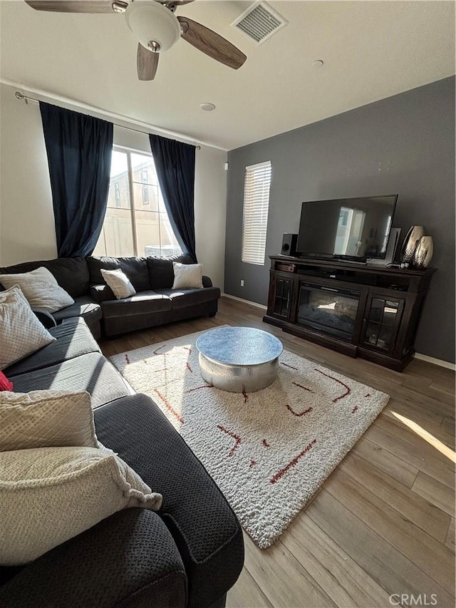 living room with hardwood / wood-style floors and ceiling fan