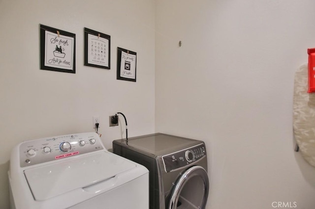 washroom with washer and dryer