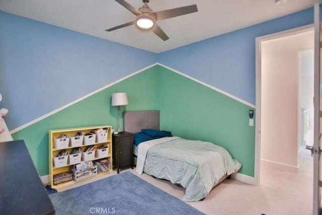 carpeted bedroom featuring vaulted ceiling and ceiling fan