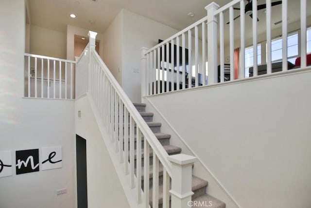 stairs featuring a high ceiling