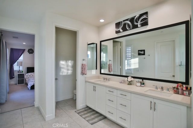 bathroom featuring tile patterned flooring, vanity, and toilet