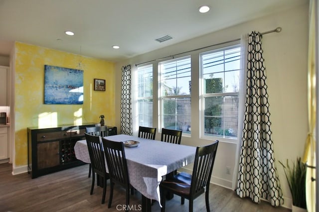 dining area featuring plenty of natural light and dark hardwood / wood-style floors