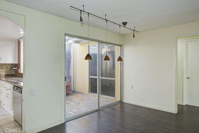 interior space featuring hardwood / wood-style flooring and a textured ceiling