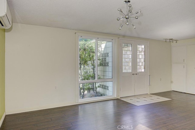 interior space featuring a healthy amount of sunlight, a wall mounted air conditioner, and dark hardwood / wood-style flooring