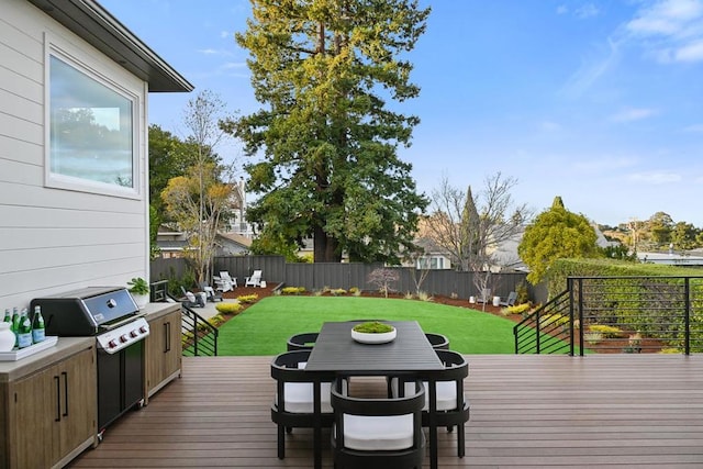 wooden deck with area for grilling and a lawn