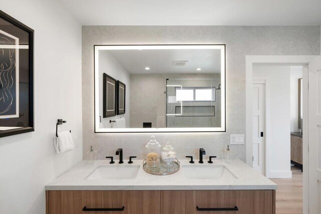 bathroom with vanity and wood-type flooring