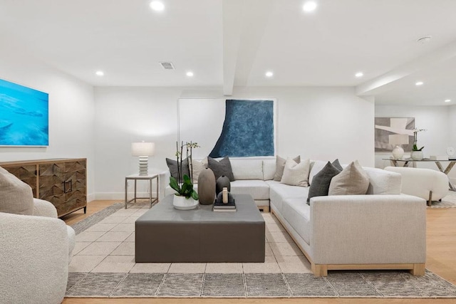 living room with beam ceiling and light hardwood / wood-style flooring