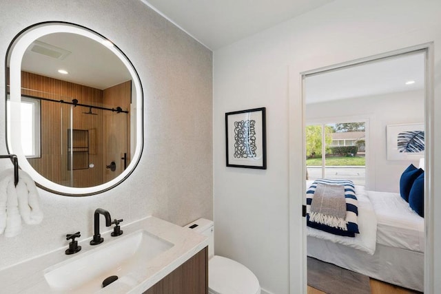 bathroom featuring vanity and toilet