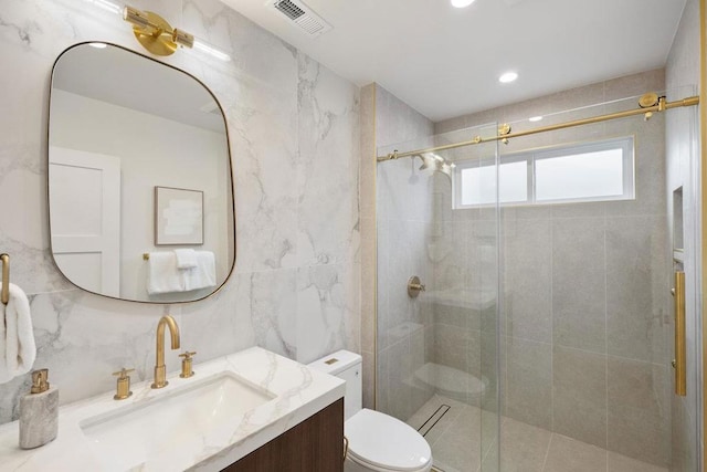 bathroom with toilet, tasteful backsplash, tile walls, vanity, and a shower with door