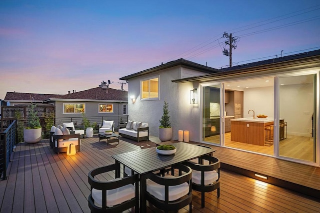 deck at dusk featuring an outdoor living space