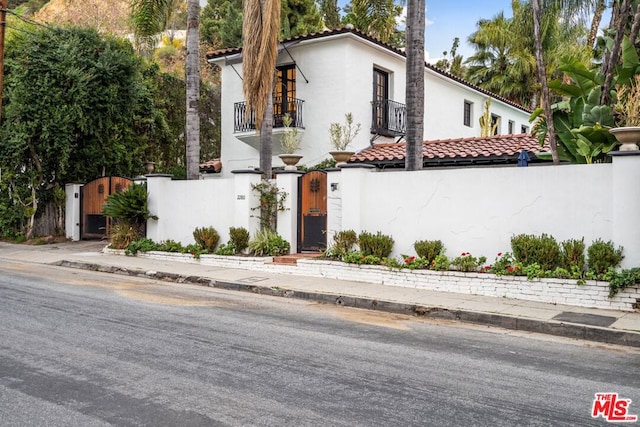 mediterranean / spanish-style home with a balcony