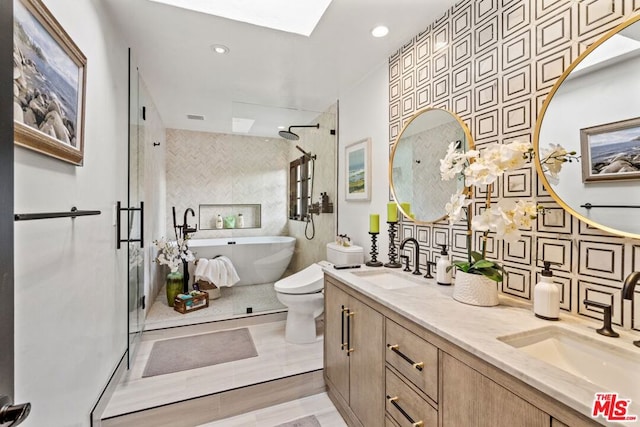 full bathroom featuring toilet, a skylight, tile walls, vanity, and plus walk in shower