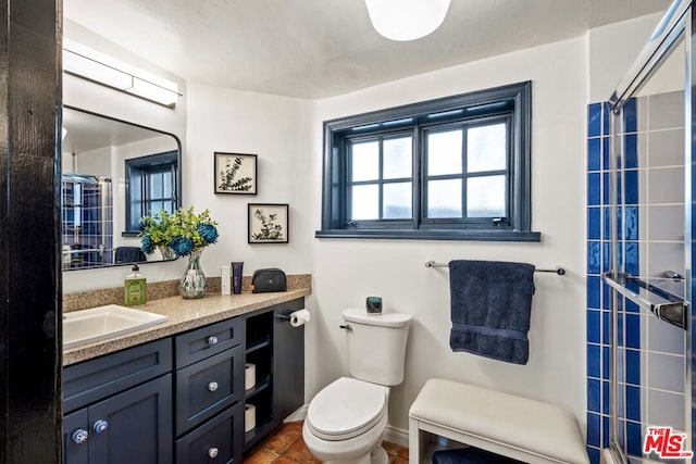 bathroom featuring vanity, tile patterned flooring, a shower, and toilet