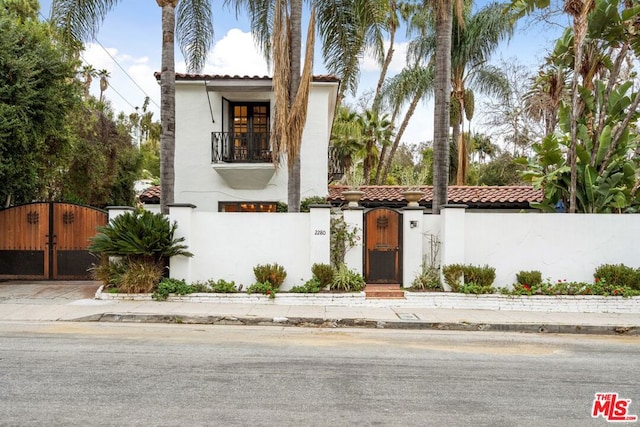 mediterranean / spanish-style home with a balcony