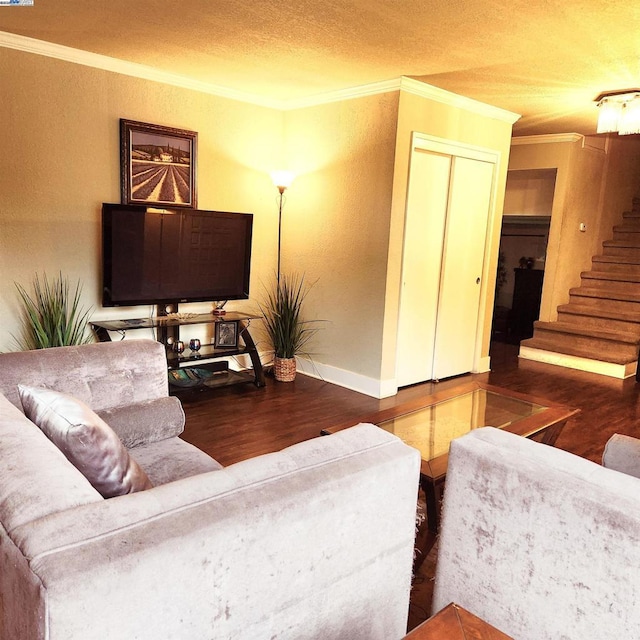 living room featuring crown molding, dark wood-type flooring, and a textured ceiling