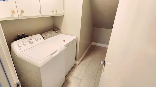 washroom featuring cabinets and separate washer and dryer