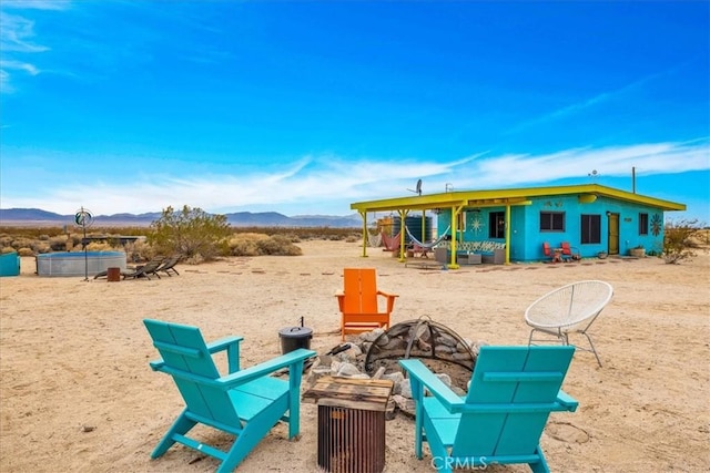 back of property featuring a pool and a mountain view