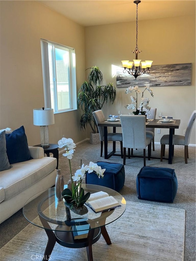 carpeted living room featuring an inviting chandelier